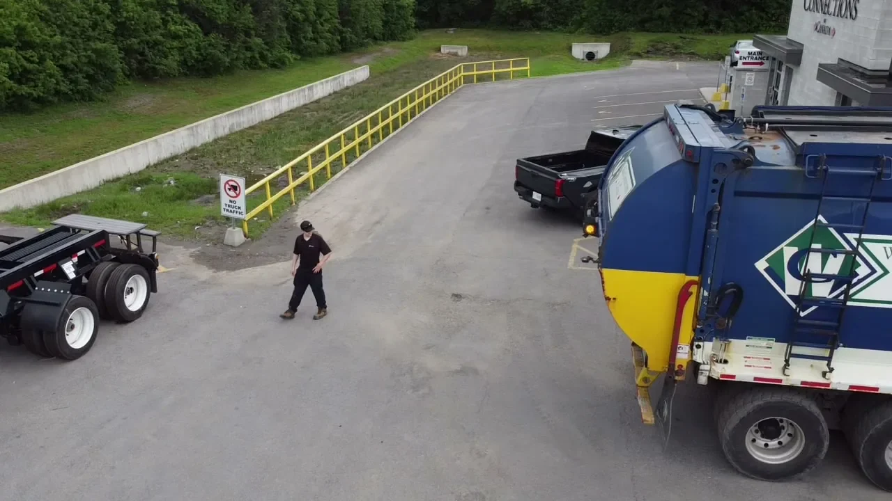 Aerial view of a Waste Connections yard with a front-load truck