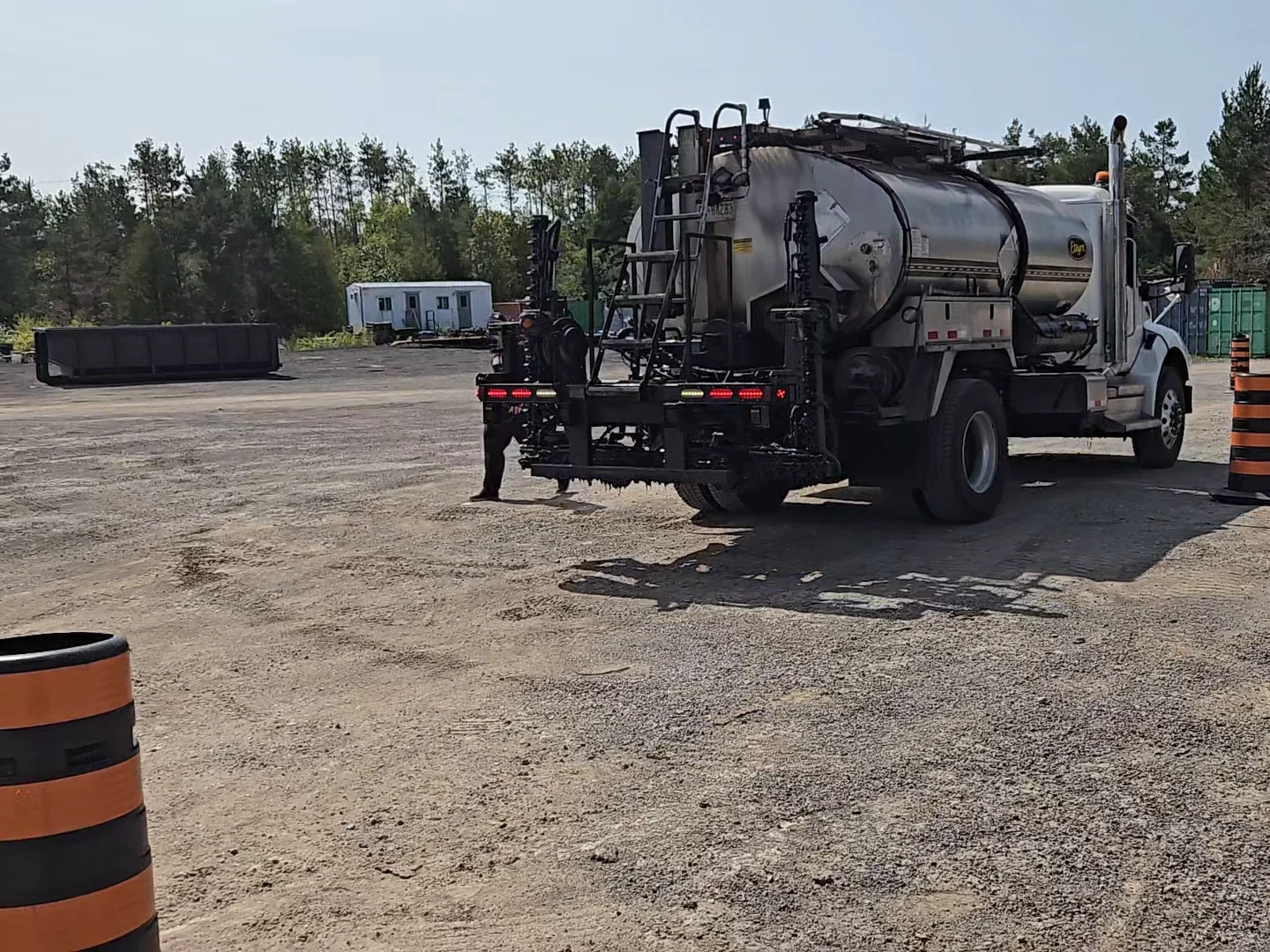 Asphalt distributor truck in a gravel yard during sensor testing