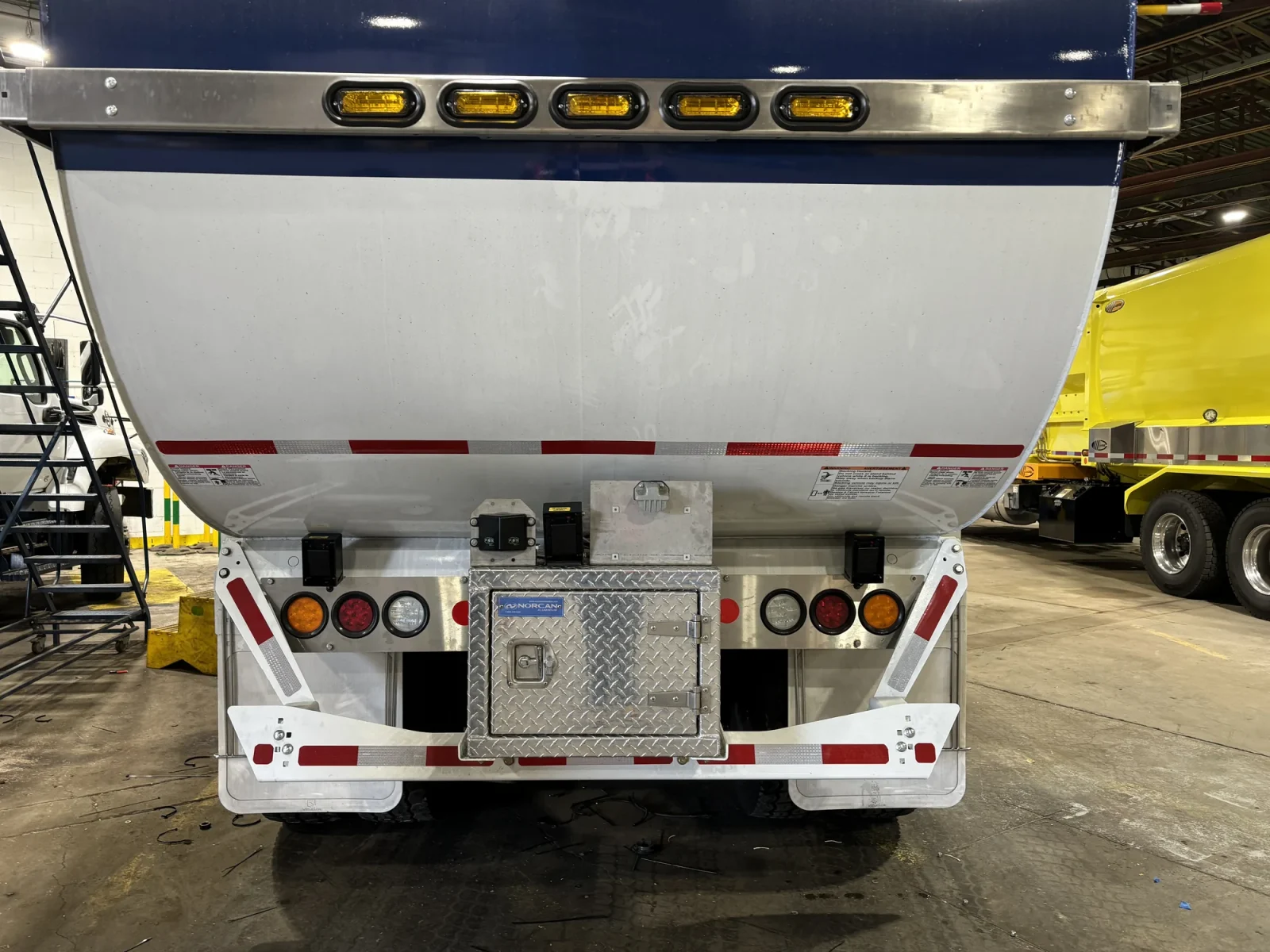 Rear of a front-load garbage truck with sensors mounted on the bumper