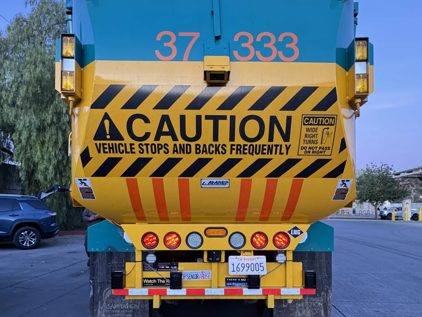 Rear of an Amrep automated side loader with sensor mounts below the bumper lights