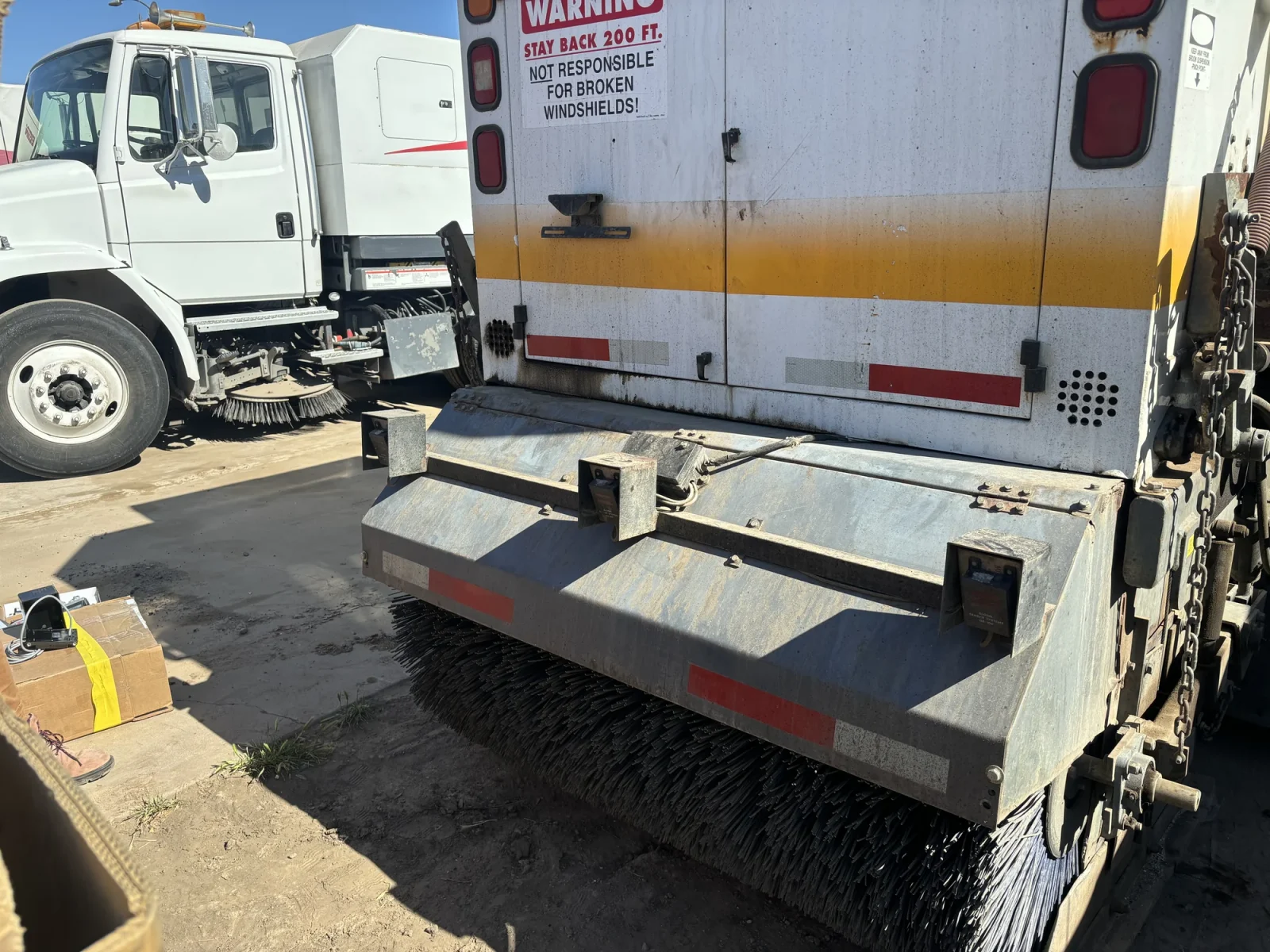 Rear of a street sweeper with sensor boxes mounted on the back